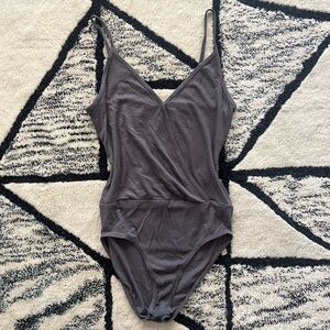 Grey bodysuit with open back cutout and snap closures